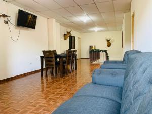 a living room with a couch and a table and chairs at Sucursal del Cielo in Concepción de Ataco
