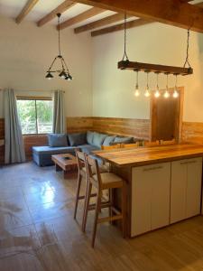 a kitchen and living room with a table and a couch at Cabaña Rústica - Sector Pichares in Pichare +14 photos