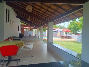 a patio with a table and chairs and a pool at Casa Da Mari in Vera Cruz de Itaparica