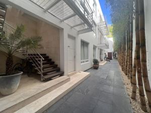 a hallway of a building with stairs and potted plants at Condesa Residence Amsterdam 303 Exquisite 1 Bedroom, 1 Bathroom Residence on Amsterdam Avenue in Mexico City