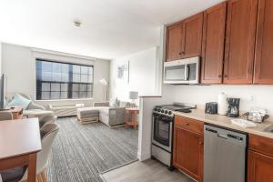 a kitchen and living room with a stove top oven at TownePlace Suites Stafford in Stafford