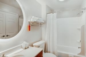 a white bathroom with a toilet and a mirror at TownePlace Suites Stafford in Stafford +26 photos