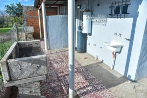 a bathroom with a sink on the side of a building at Alojamiento Moni in Villa Elisa