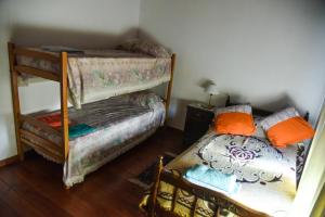 a room with two bunk beds and a bed at Alojamiento Moni in Villa Elisa