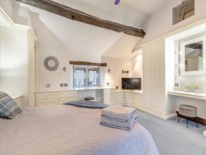 a white bedroom with a bed and a tv at Dale House Farm - Uk46033 in Monyash