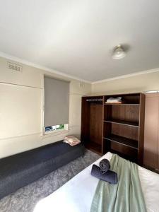 a bedroom with a bed and a window in it at Shepparton House in Shepparton