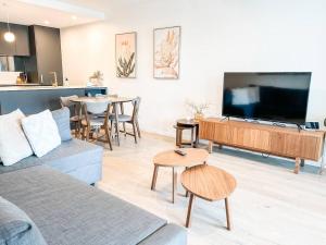 a living room with a large flat screen tv at Metropol - CBD pool Sleeps 7 in Canberra
