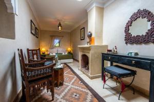 a living room with a fireplace and a couch at Riad dar Ourika in Marrakesh