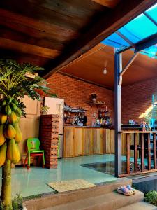 a patio with a kitchen and a counter with a table at Nhà Sàn Bên Suối in Buôn Ðũng