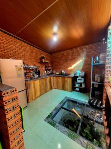 a kitchen with a fish tank in the middle of a room at Nhà Sàn Bên Suối in Buôn Ðũng