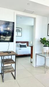 a living room with a bed and a table at Monte Carlo Suites in Miami Beach in Miami Beach