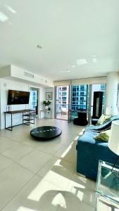 a large living room with a couch and a tv at Monte Carlo Suites in Miami Beach in Miami Beach