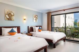 Letto o letti in una camera di Ratana Angkor Hotel
