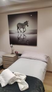 a bedroom with a picture of a zebra on the wall at Llac Blau 1 in El Tarter