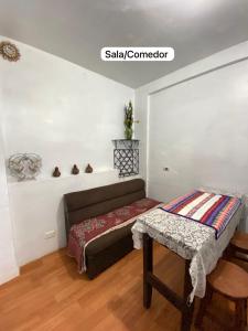 a small room with a bed and a table at Casa Katya Cusco in Cusco