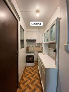 a kitchen with a door open to a kitchen with at Casa Katya Cusco in Cusco