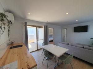 a living room with a couch and a table and chairs at The African Reef in Geraldton