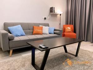 a living room with a couch and a coffee table at LuxuryHomestay @Pinetree Marina Resort - Link House in Nusajaya
