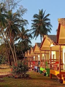 une rangée de maisons avec des palmiers en arrière-plan dans l'établissement Last Hammock Beach Resort, à Ko Pha Ngan
