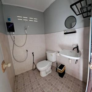 a bathroom with a shower and a toilet and a sink at Last Hammock Beach Resort in Ko Phangan