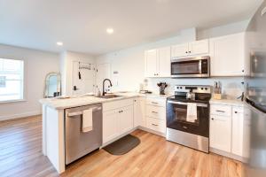 a kitchen with white cabinets and stainless steel appliances at Cozy Luxury Living in Auburn, Your Stylish Escape - 2BD 1BA Apartment, Free Parking, WiFi & Balcony! in Auburn