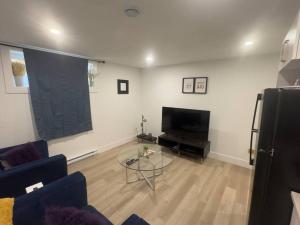 a living room with a couch and a table at Cozy Apartment close to Airport in Dieppe