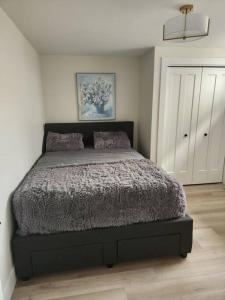 a bedroom with a large bed in a room at Cozy Apartment close to Airport in Dieppe