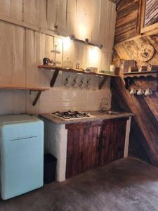 a kitchen with a stove and a sink in it at Hermosa y Nueva Cabaña de campo - La Candelaria Farm House in Cuenca