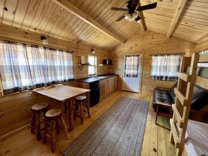 a kitchen with a table and chairs in a cabin at Zion Canyon Cabins in Springdale