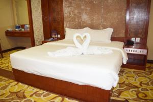 Postel nebo postele na pokoji v ubytování Dansavanh Vientiane Hotel