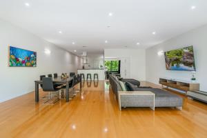 a living room and dining room with a dining table at Serpentine Park on View in Bendigo