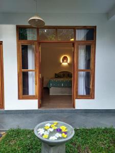 a table in front of a house with a bedroom at All View Resort in Tangalle