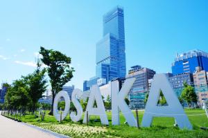 a large sign in front of a city at かまどと壺湯之宿 大阪ミナミ–Residence inn Kamado and Tsuboyu- in Osaka