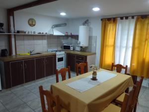 a kitchen with a table with a yellow table cloth at El Elyon Duplex in Santa Rosa de Calamuchita