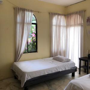 Postel nebo postele na pokoji v ubytování Veranera Hostal