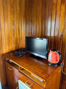 a television sitting on top of a wooden table at Sunset View-Villa in Pacific Harbour