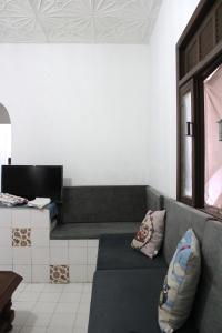 a living room with a couch and a desk at Casa de Alvenaria- Mauá in Mauá