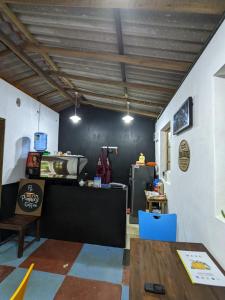 a room with a kitchen with a counter and a table at Little Pumpkin Cabanas in Tangalle