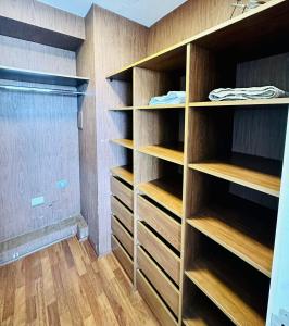 a walk in closet with wooden shelves at Arauco Premium Suite in Santiago