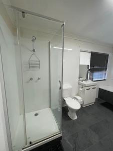 a bathroom with a shower and a toilet at The Park Motel in Charters Towers