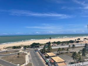 a view of a beach with palm trees and a road at Studio Completo, Condominio Grand Smart Residence in Aracaju
