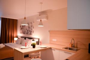Zimmer mit einem Bett und einer Küche mit einem Tisch in der Unterkunft Yes Апарт-отель in Astana