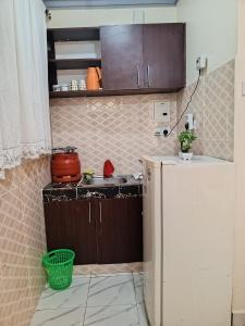 a small kitchen with a refrigerator and a sink at Jackie homes in Mombasa