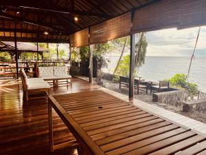 a porch of a resort with a view of the ocean at Villa Milagros Dive Inn Anilao in Mabini