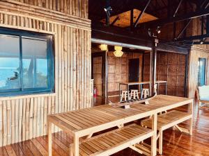 a wooden bench in a room with a window at Villa Milagros Dive Inn Anilao in Mabini