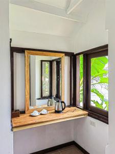 a mirror on a counter in a room with windows at Phi Phi Private Beach Resort in Phi Phi Islands