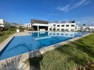 a large swimming pool in front of a building at Bonita casa muy cómoda y con piscina in Naranjo