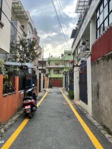 a scooter parked on the side of a street at Lilen's Homestay-Entire Apartment with Private Bathroom and Kitchen in Kathmandu
