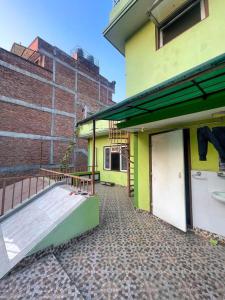 a building with a balcony with a tennis court on it at Lilen's Homestay-Entire Apartment with Private Bathroom and Kitchen in Kathmandu
