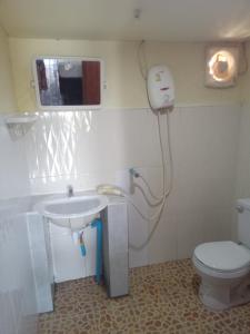 a bathroom with a sink and a toilet at Friendship Guest House in Don Det